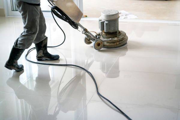 Contractor Cleaning Concrete Floor Before Burnishing