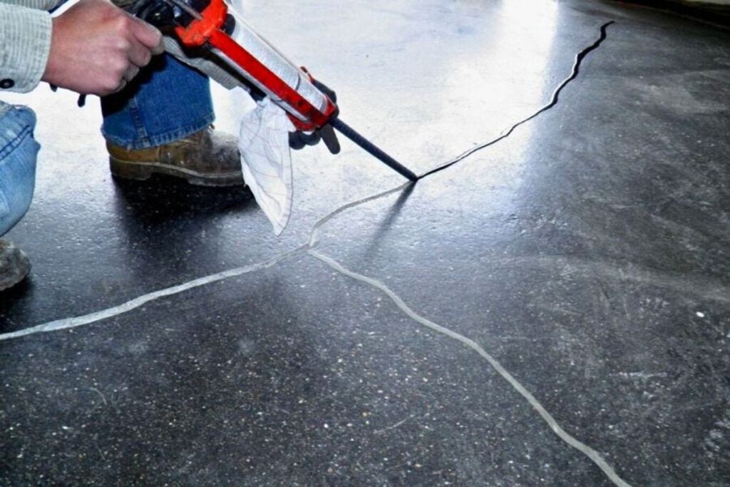 concrete contractor repairing concrete cracks