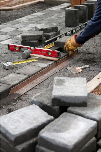 concrete worker installing paver