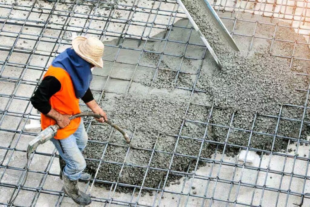 professional contractor pouring concrete on old concrete